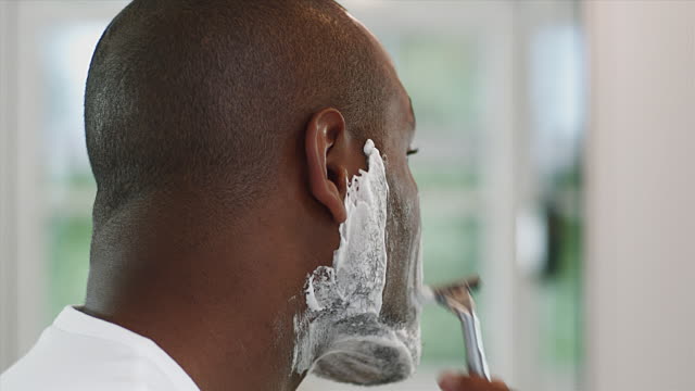Nigerian man shaving